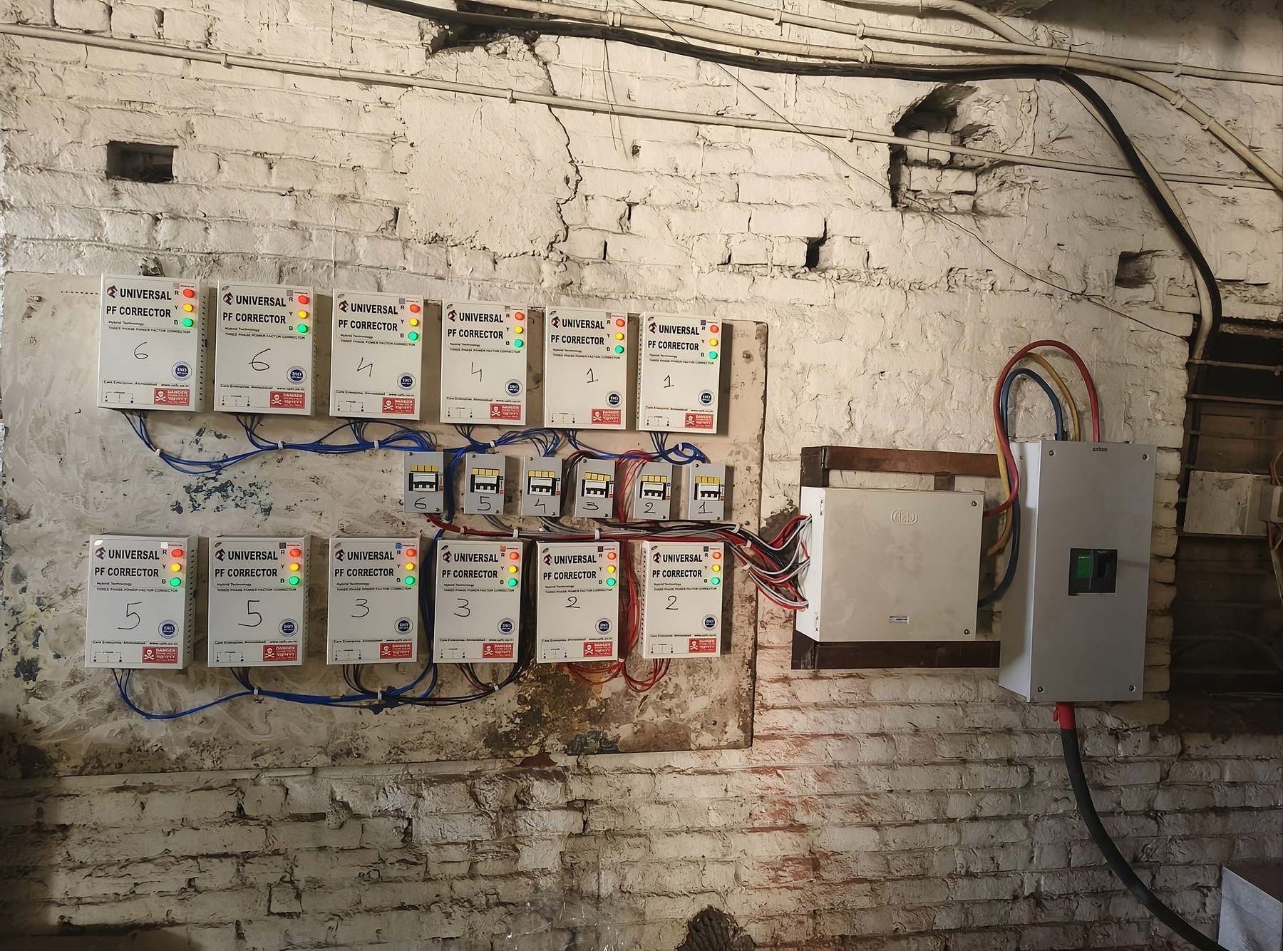 Universal PF Corrector units numbered and wired to a distribution board